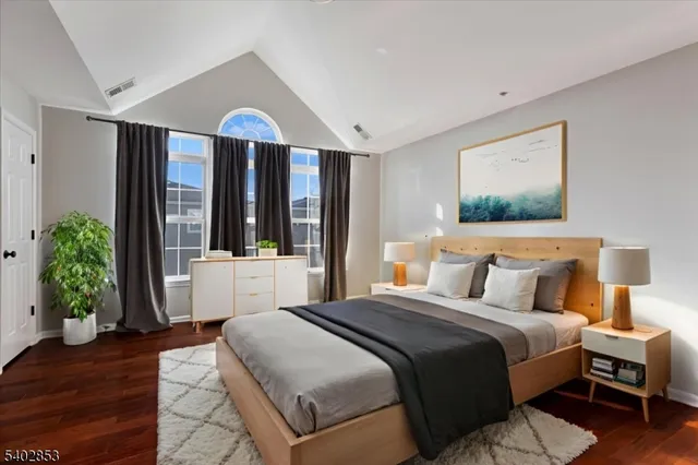 a bedroom with a large bed and a large window