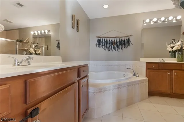 a bathroom with a sink a mirror and a bathtub