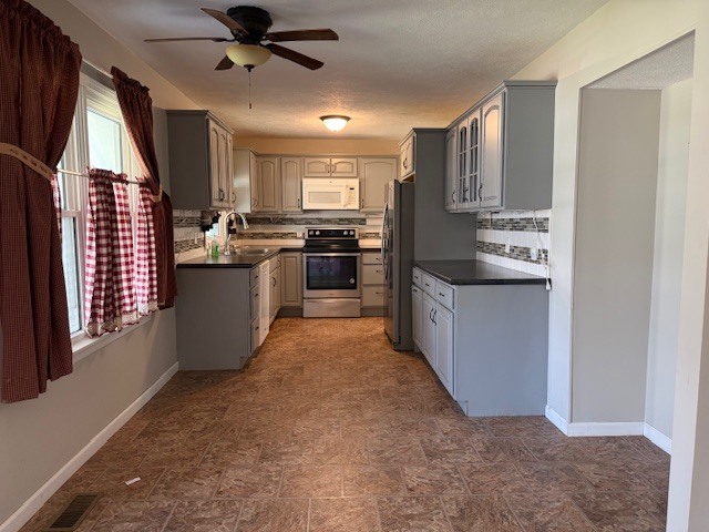 302 West Ward Street Energy, IL 62933 - Photo 7 of 37 a kitchen with stainless steel appliances kitchen island granite countertop a refrigerator a sink dishwasher a stove and a refrigerator