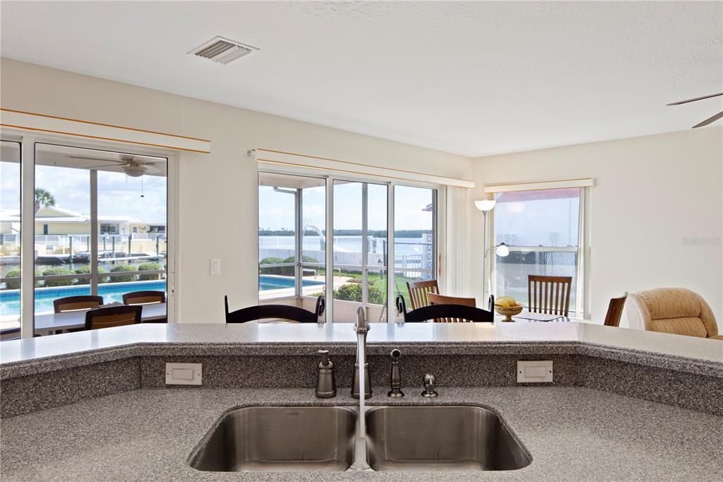 4964 South Shore Drive New Port Richey, FL 34652 - Photo 14 of 69 a kitchen with a large window and couch