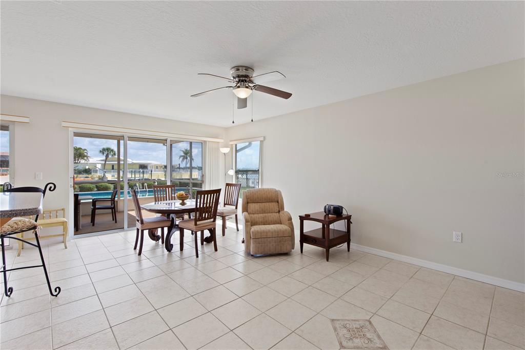 4964 South Shore Drive New Port Richey, FL 34652 - Photo 19 of 69 a dining room with furniture and a chandelier