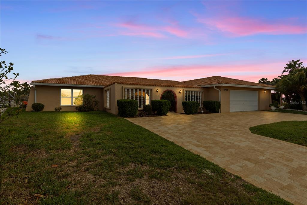 4964 South Shore Drive New Port Richey, FL 34652 - Photo 2 of 69 a front view of house with yard and green space