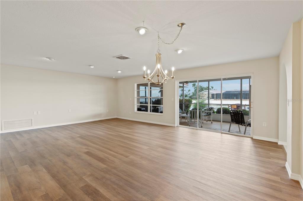 4964 South Shore Drive New Port Richey, FL 34652 - Photo 27 of 69 a view of an empty room with wooden floor and a window