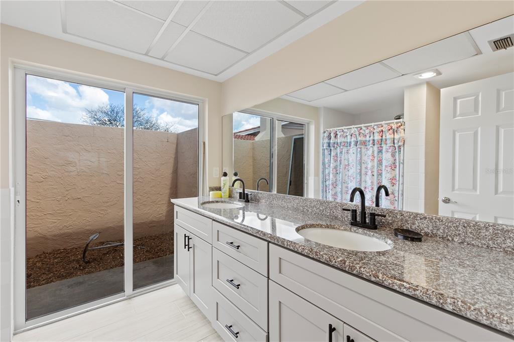 4964 South Shore Drive New Port Richey, FL 34652 - Photo 31 of 69 a bathroom with a granite countertop sink mirror and double