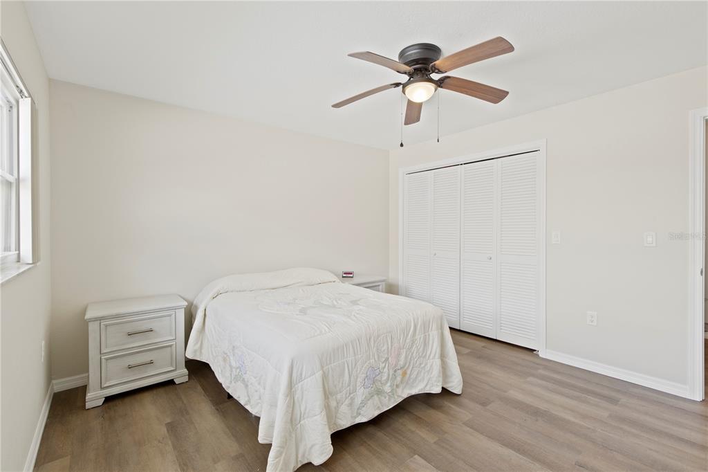 4964 South Shore Drive New Port Richey, FL 34652 - Photo 32 of 69 a bedroom with a bed and a ceiling fan