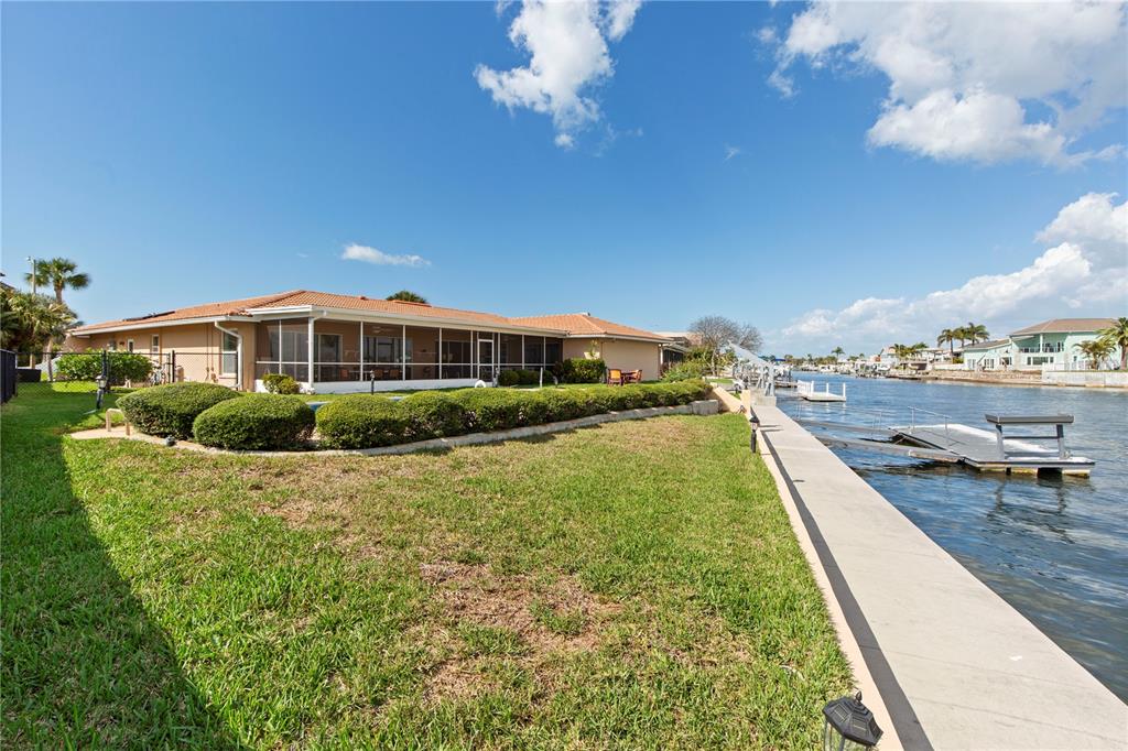4964 South Shore Drive New Port Richey, FL 34652 - Photo 48 of 69 a view of a house with a yard