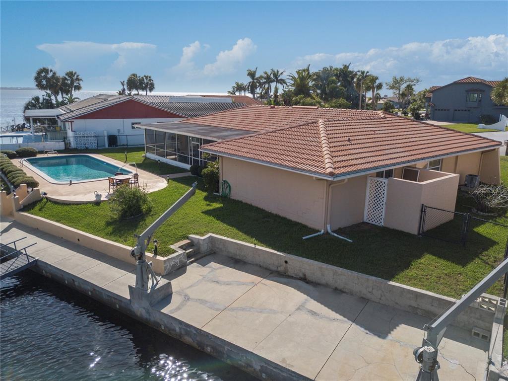 4964 South Shore Drive New Port Richey, FL 34652 - Photo 49 of 69 a view of a patio with a table and chairs