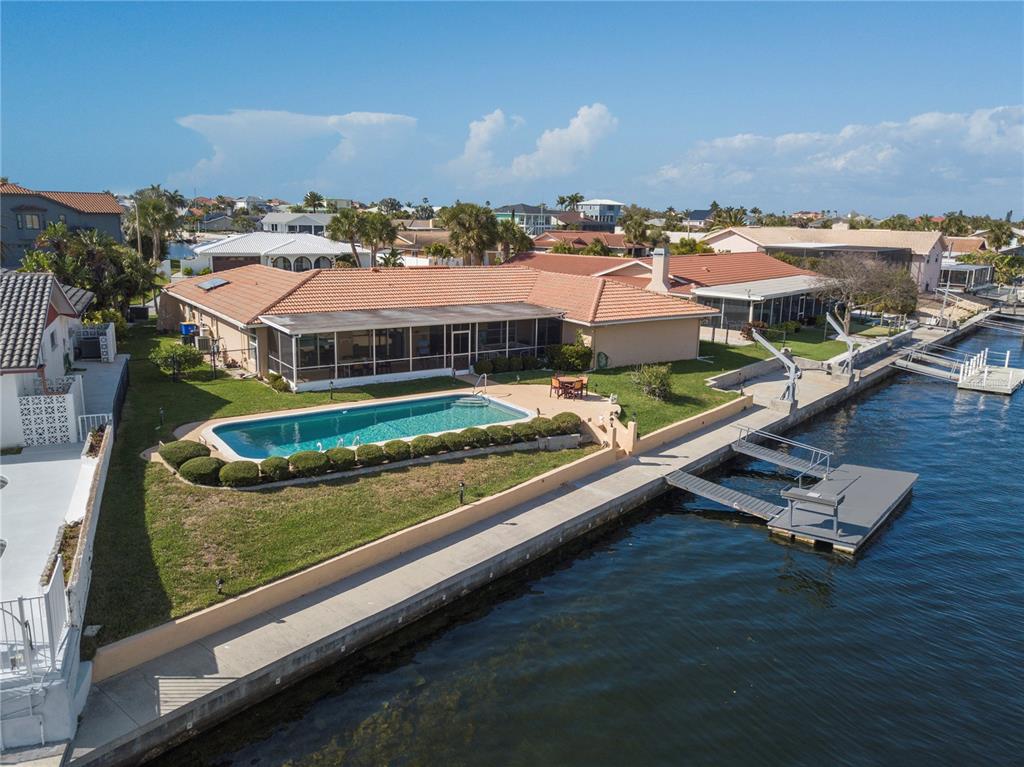 4964 South Shore Drive New Port Richey, FL 34652 - Photo 50 of 69 an aerial view of residential houses with outdoor space and swimming pool