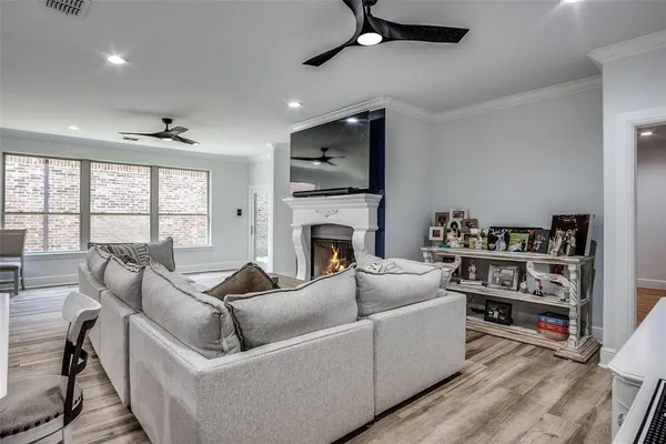 a living room with furniture a flat screen tv and a fireplace