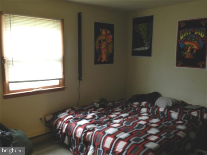 14 Girard Road South Glassboro, NJ 08028 - Photo 12 of 25 a bed sitting in a bedroom next to a window