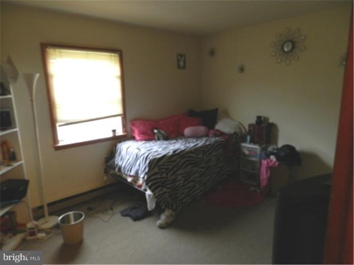 14 Girard Road South Glassboro, NJ 08028 - Photo 16 of 25 a bed sitting in a bedroom next to a window