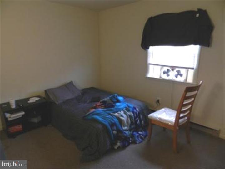 14 Girard Road South Glassboro, NJ 08028 - Photo 23 of 25 a bed sitting in a bedroom next to a window