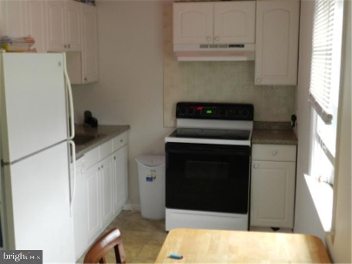 14 Girard Road South Glassboro, NJ 08028 - Photo 8 of 25 a kitchen with a refrigerator and a stove
