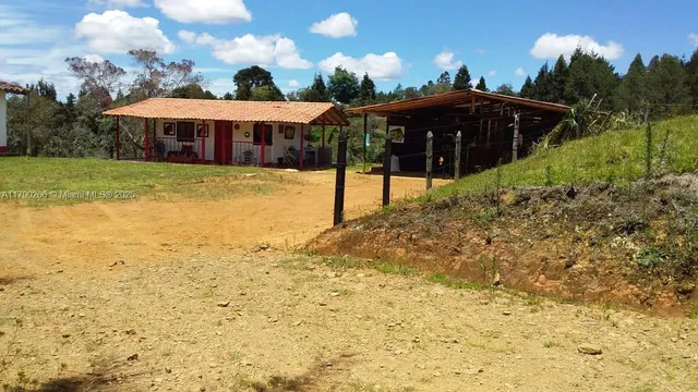 a view of a house with a yard and sitting area