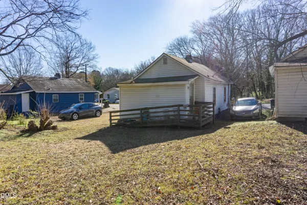 a view of a house with a yard covered in snow