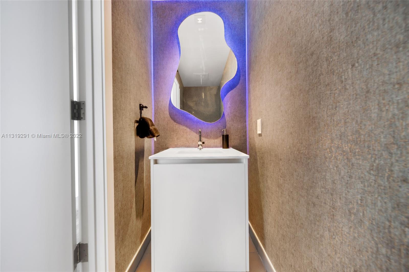 Edgewater Miami, FL 33137 - Photo 17 of 23 a bathroom with a sink and mirror