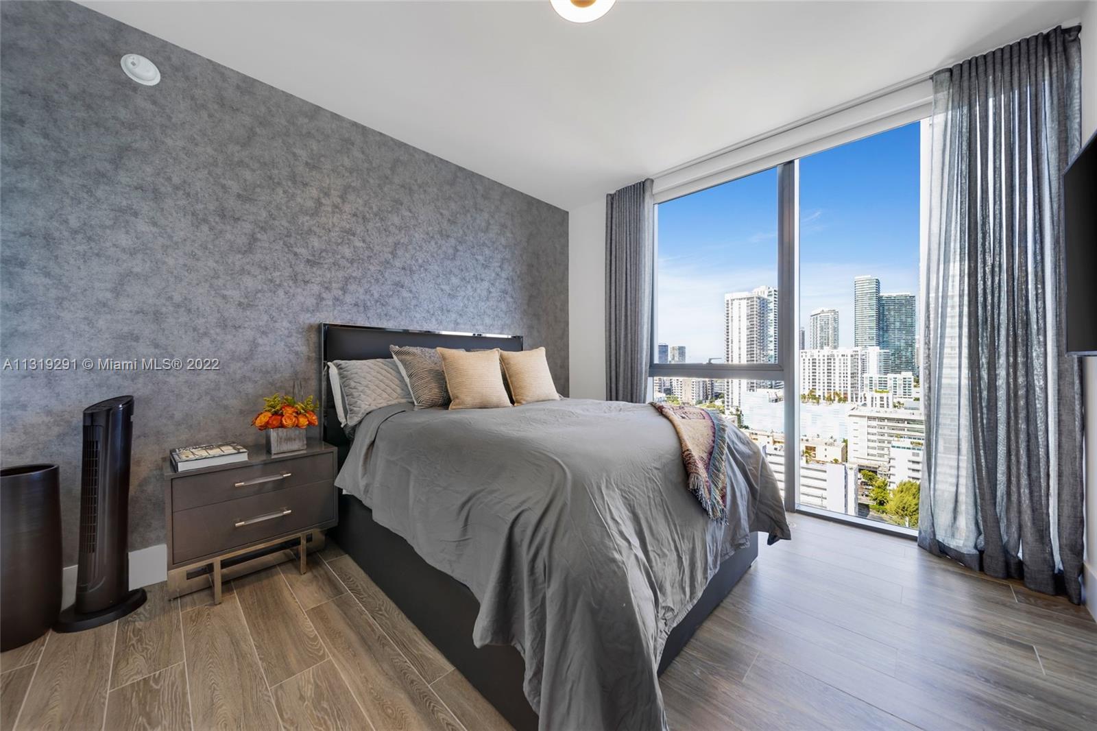 Edgewater Miami, FL 33137 - Photo 18 of 23 a bedroom with a bed and large window