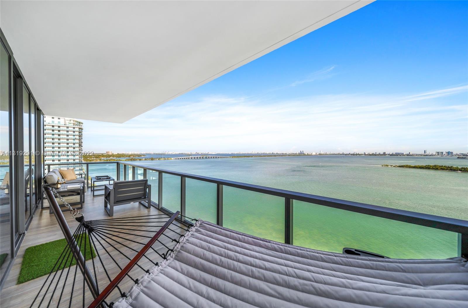 Edgewater Miami, FL 33137 - Photo 20 of 23 a view of a balcony with wooden floor and outdoor space