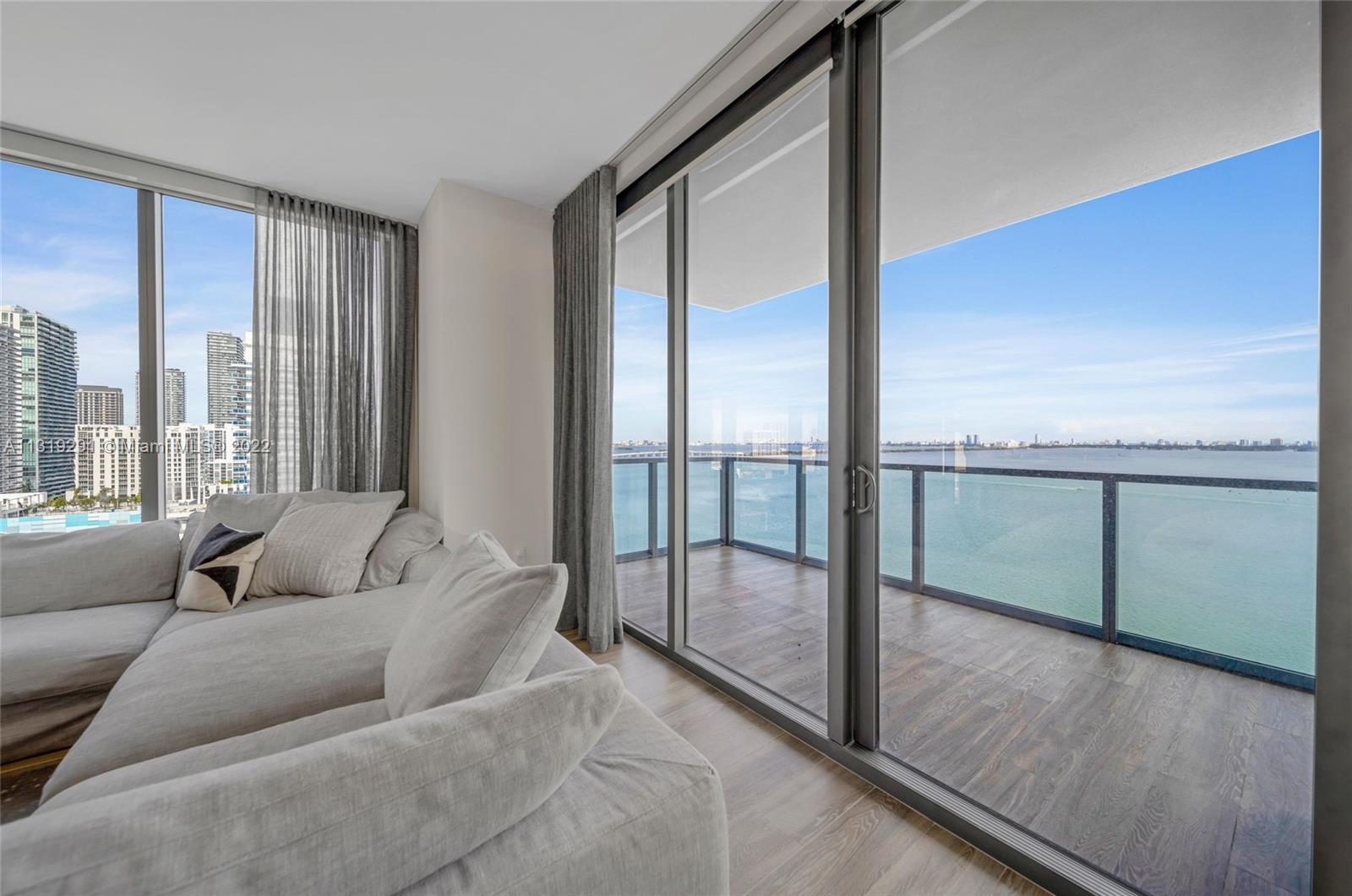Edgewater Miami, FL 33137 - Photo 4 of 23 a living room with furniture and a floor to ceiling window