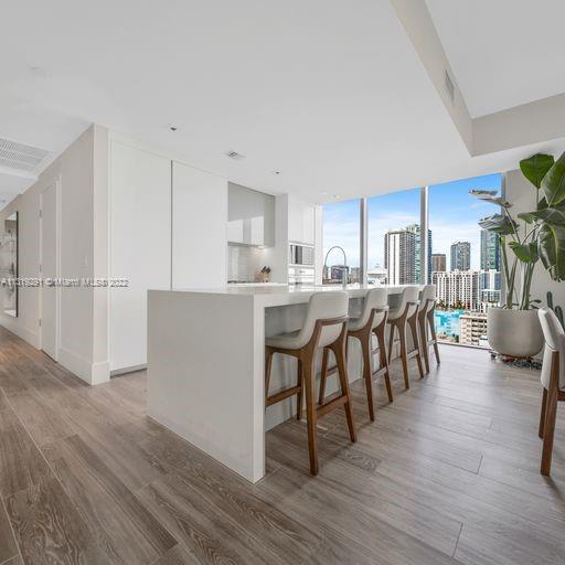 Edgewater Miami, FL 33137 - Photo 6 of 23 a kitchen with stainless steel appliances a table chairs refrigerator and cabinets