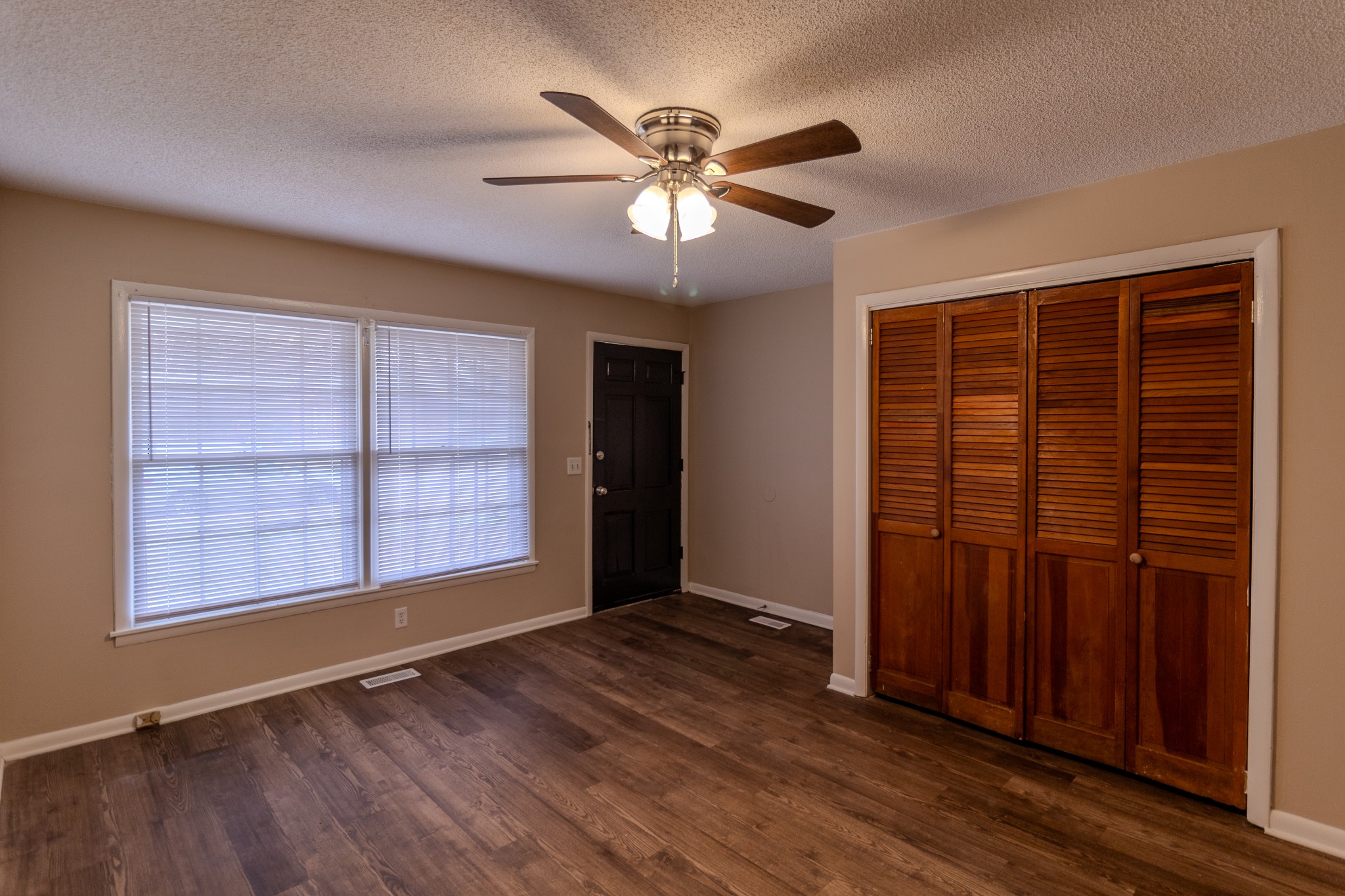 814 Riviera Drive Murfreesboro, TN 37130 - Photo 3 of 8 an empty room with wooden floor closet and windows