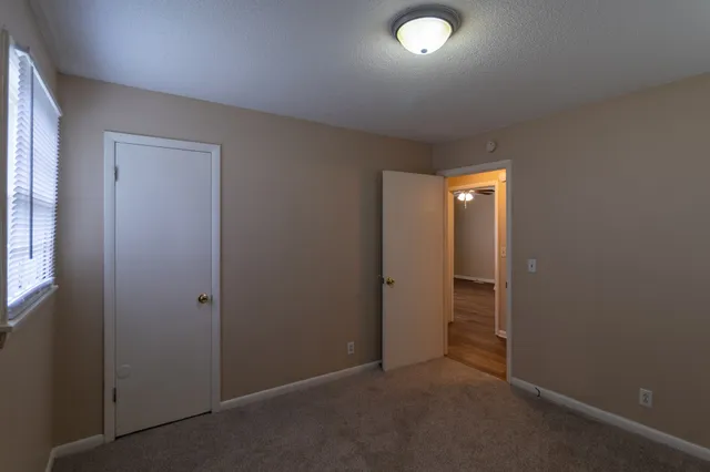 an empty room with closet area