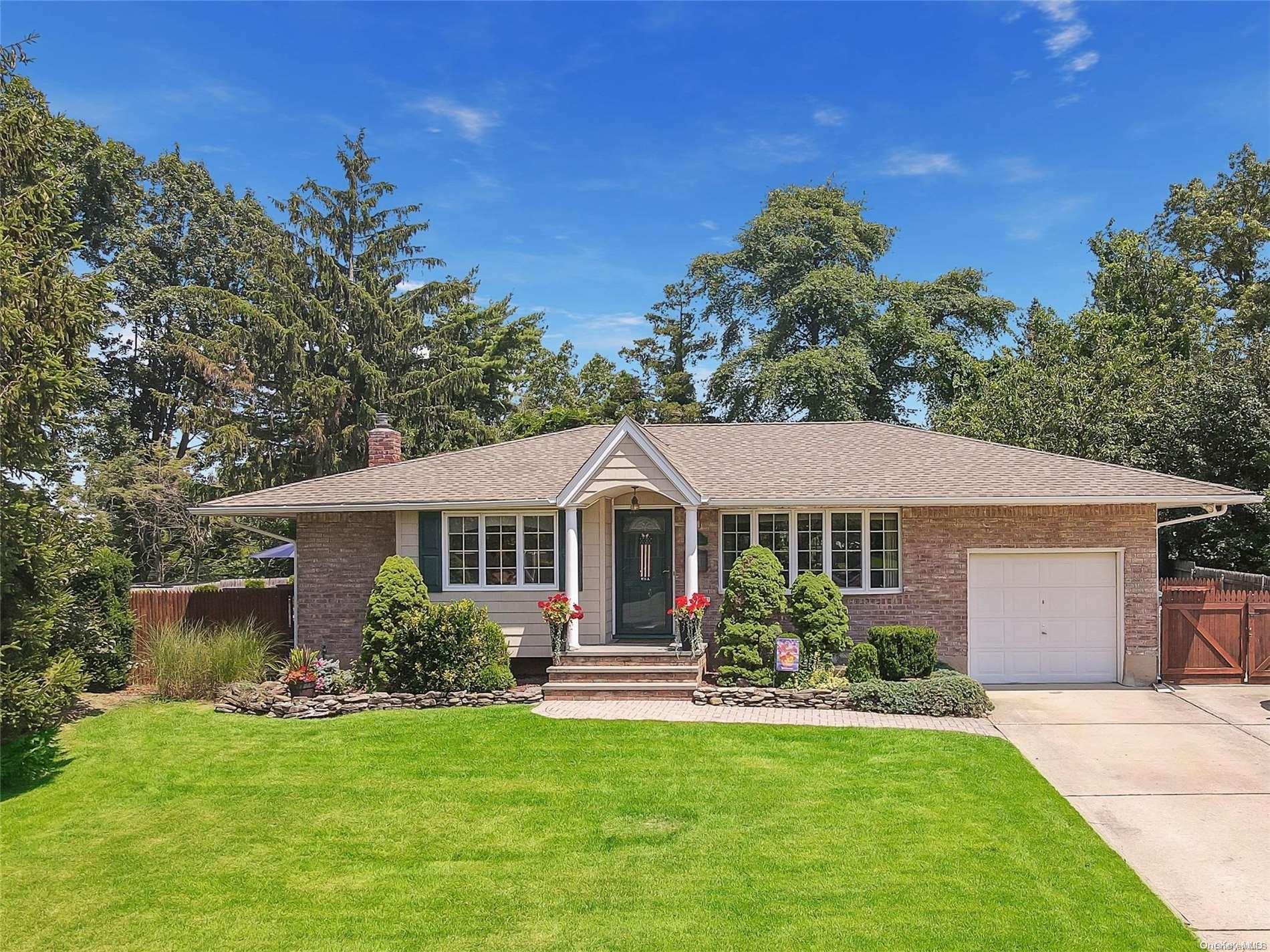25 Rita Crescent Commack, NY 11725 - Photo 1 of 1 a front view of a house with a garden