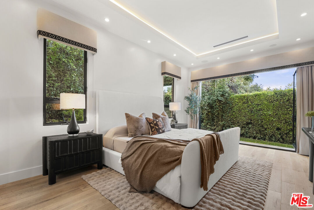 9782 Oak Pass Road Beverly Hills, CA 90210 - Photo 14 of 27 a bedroom with double bed and a large window