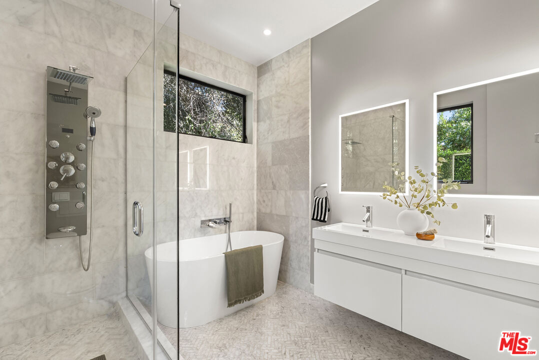 9782 Oak Pass Road Beverly Hills, CA 90210 - Photo 19 of 27 a bathroom with a double vanity sink mirror and shower