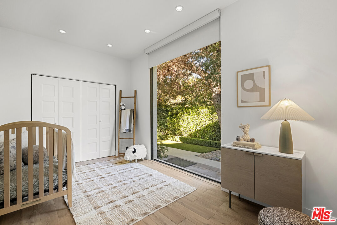 9782 Oak Pass Road Beverly Hills, CA 90210 - Photo 20 of 27 a bedroom with a bed and a window