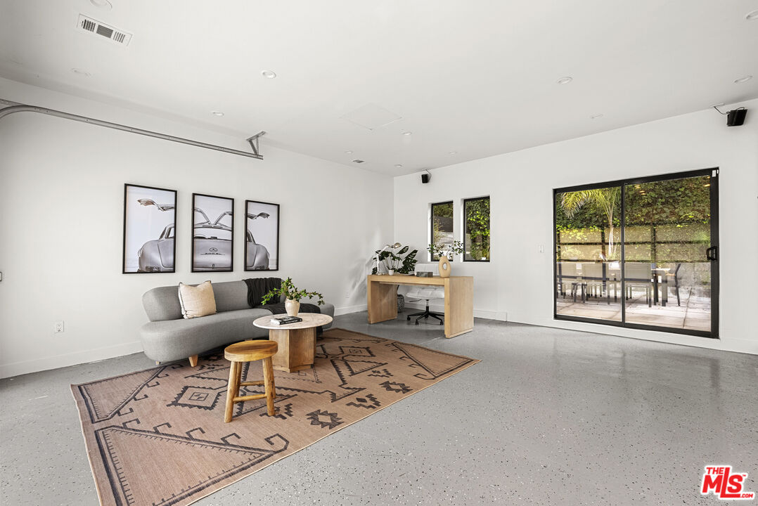 9782 Oak Pass Road Beverly Hills, CA 90210 - Photo 22 of 27 a living room with furniture and a large window