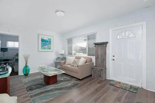 a living room with furniture a window and a table