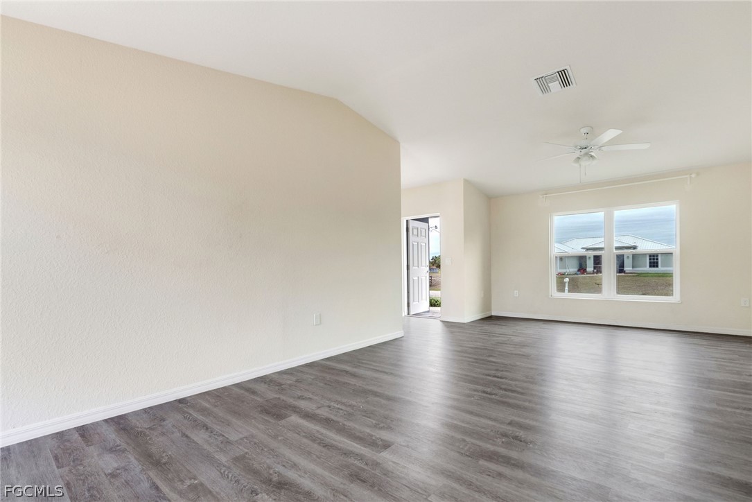 1405 Inwood Road LaBelle, FL 33935 - Photo 9 of 35 a view of an empty room with wooden floor and a window