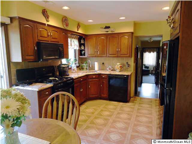 209 Cherry Quay Road Brick, NJ 08723 - Photo 8 of 24 a kitchen with a sink stove and refrigerator
