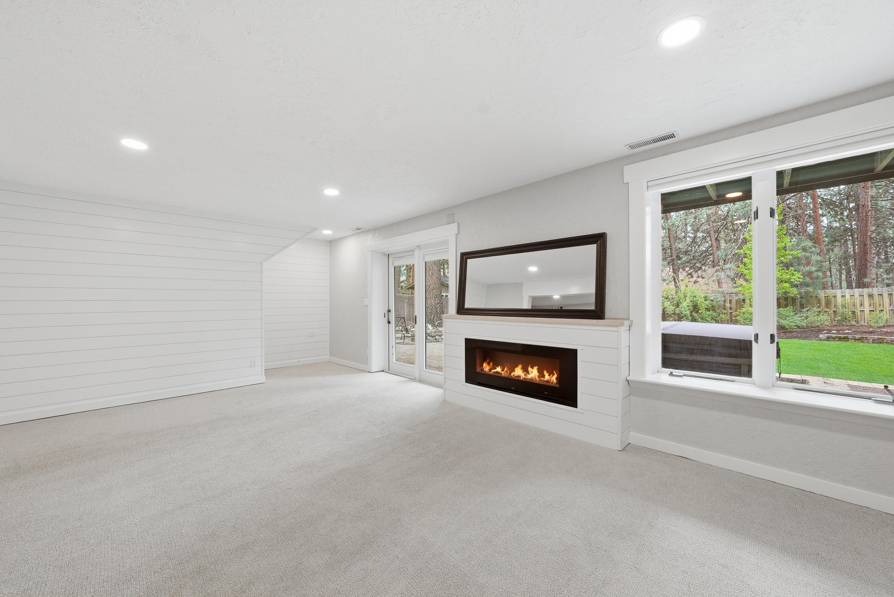 1961 Southwest Knoll Avenue Bend, OR 97702 - Photo 31 of 53 a view of an empty room with a fireplace and a window