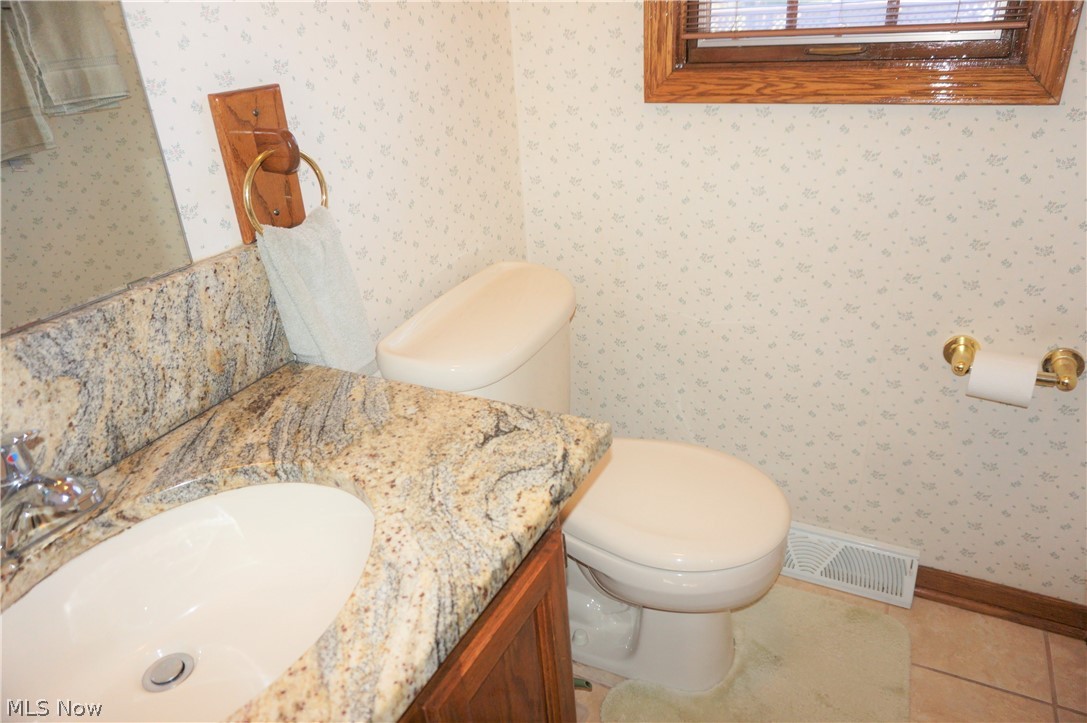 2577 Sourek Road Akron, OH 44333 - Photo 15 of 35 Main floor half bath granite counters and porcelain floor