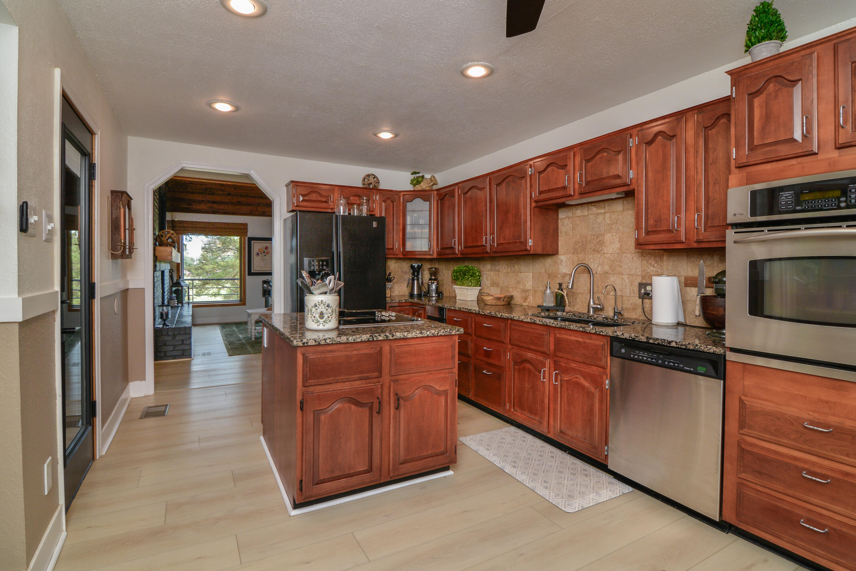 69 South Lake Shore Drive Ransom Canyon, TX 79366 - Photo 15 of 49 a kitchen with stainless steel appliances granite countertop wooden cabinets a stove top oven a sink and dishwasher