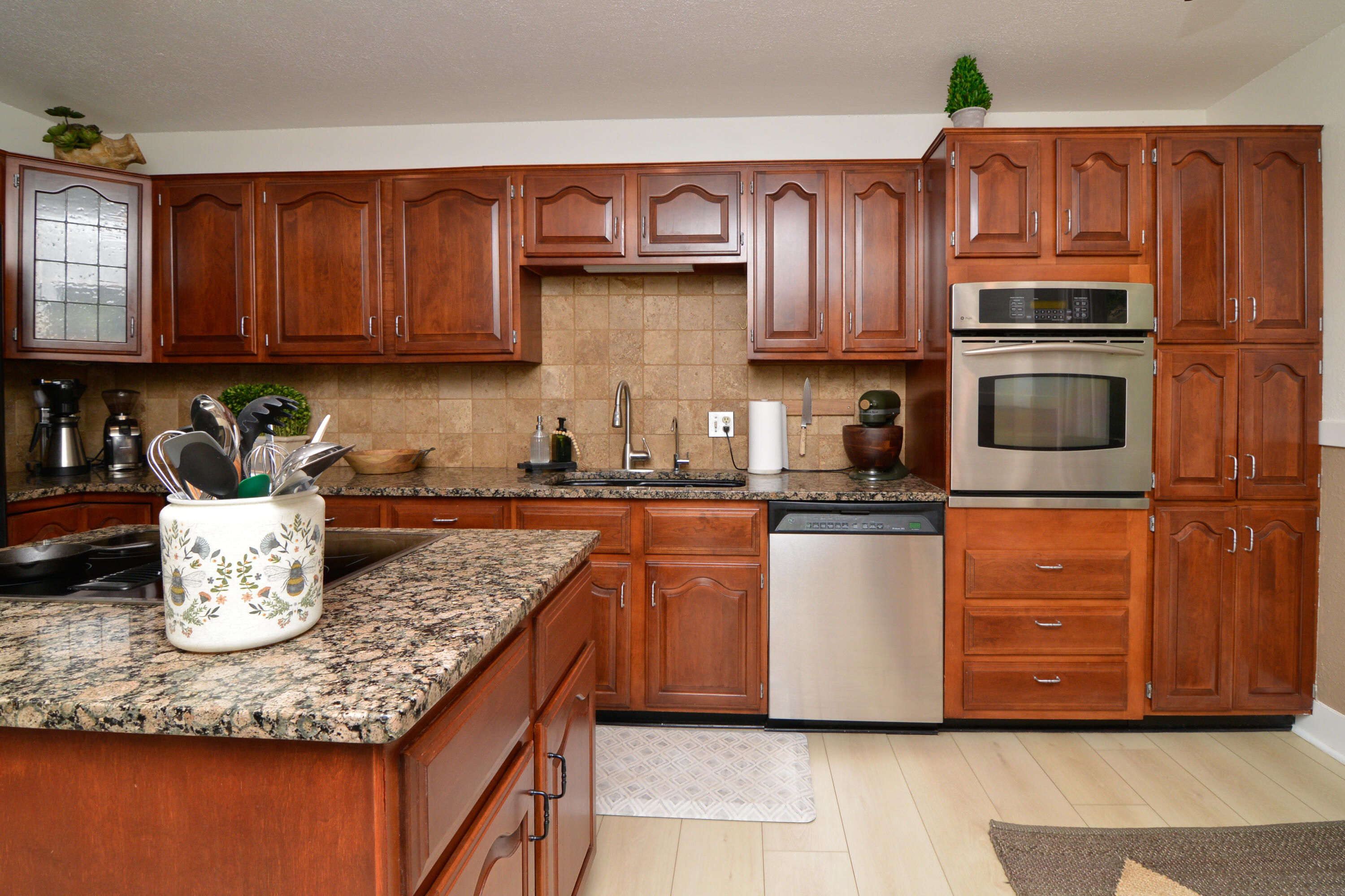 69 South Lake Shore Drive Ransom Canyon, TX 79366 - Photo 16 of 49 a kitchen with kitchen island granite countertop wooden cabinets a sink and dishwasher