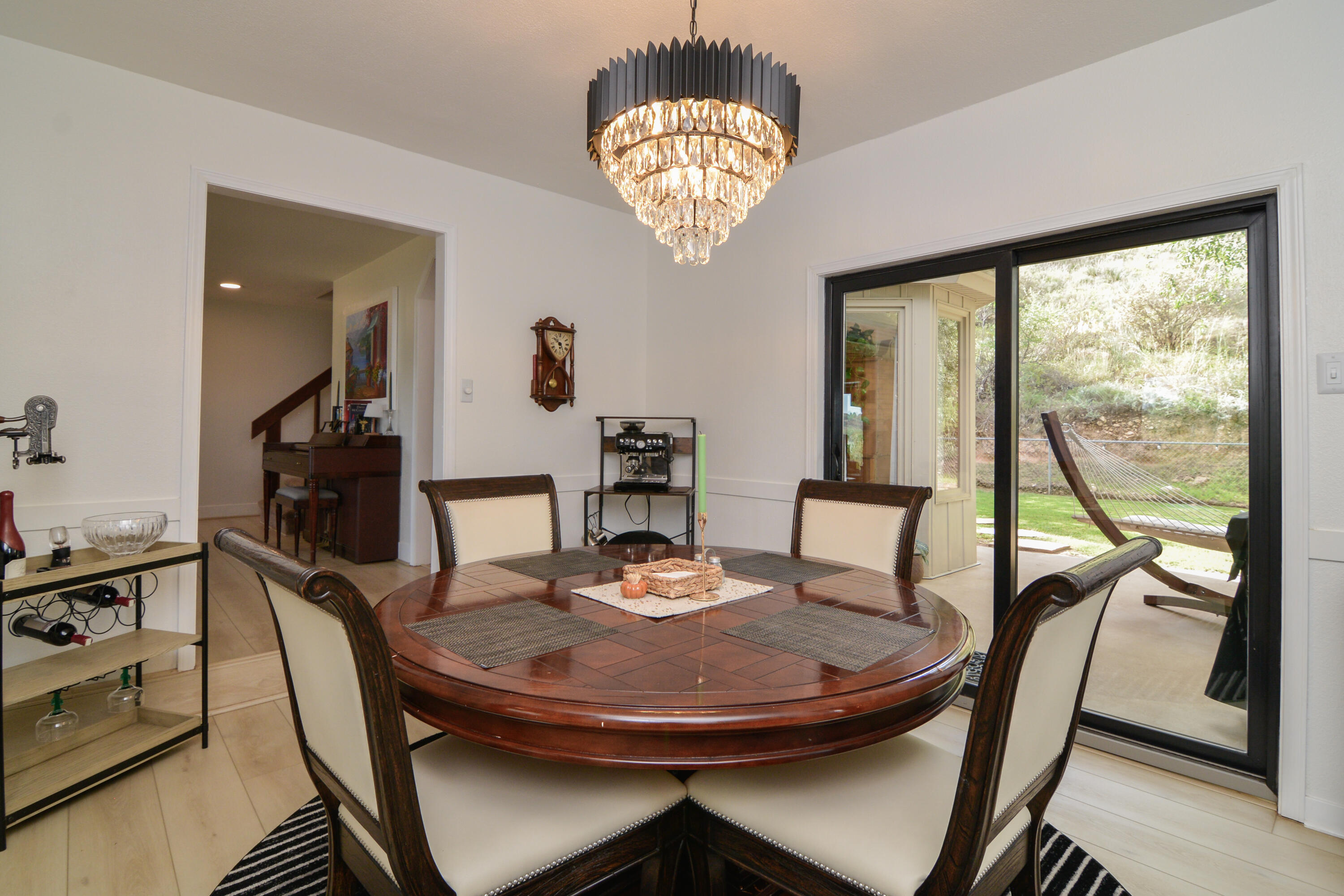 69 South Lake Shore Drive Ransom Canyon, TX 79366 - Photo 20 of 49 a view of a dining room with furniture a chandelier and wooden floor