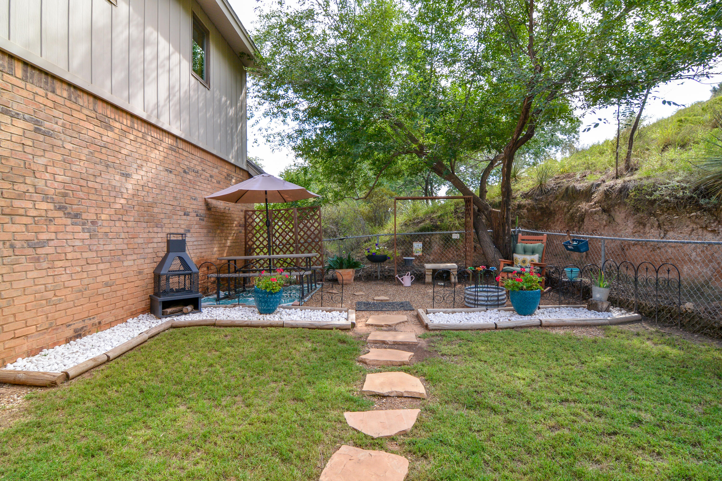 69 South Lake Shore Drive Ransom Canyon, TX 79366 - Photo 46 of 49 a view of a backyard with sitting area