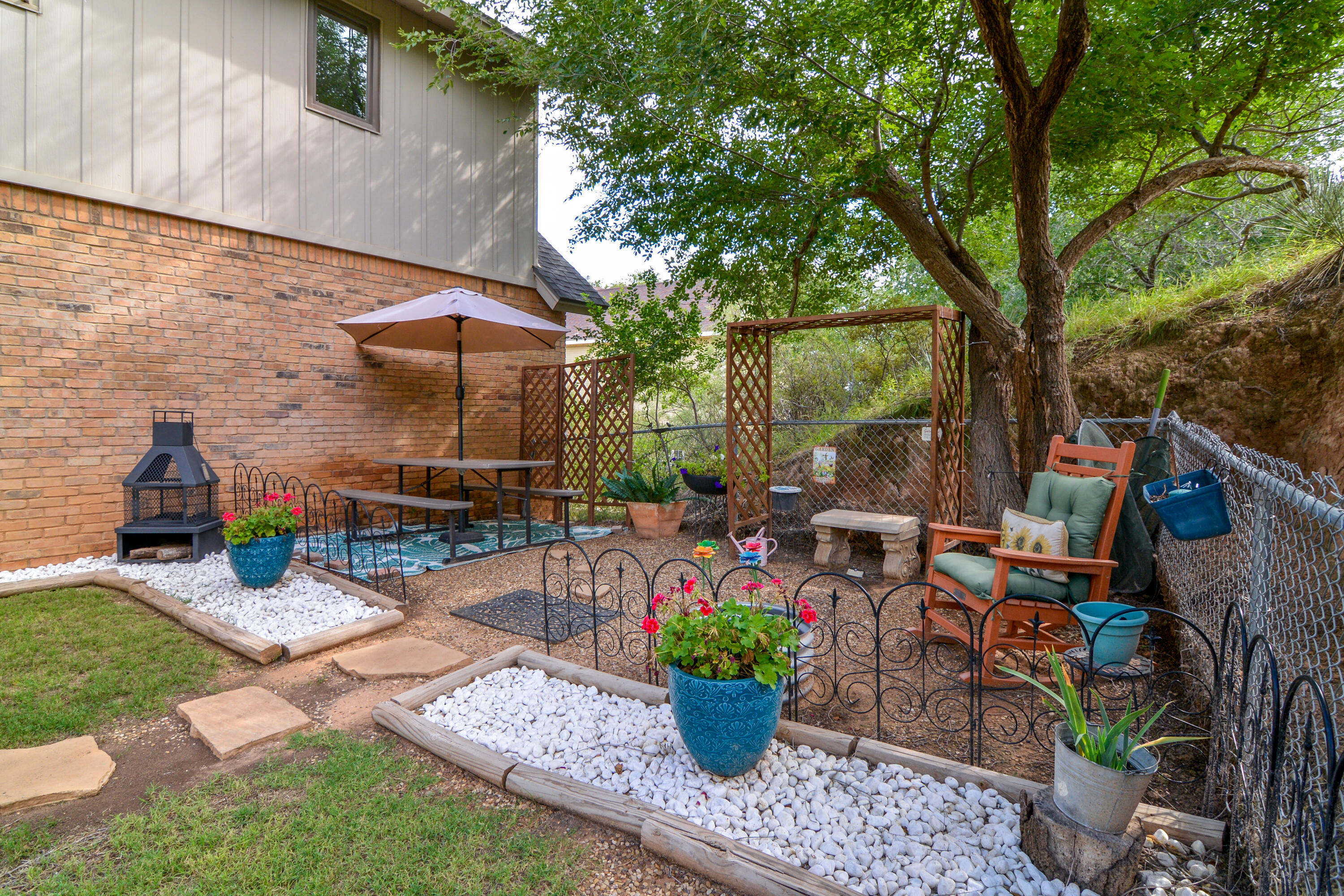 69 South Lake Shore Drive Ransom Canyon, TX 79366 - Photo 47 of 49 a view of a chairs and table in backyard