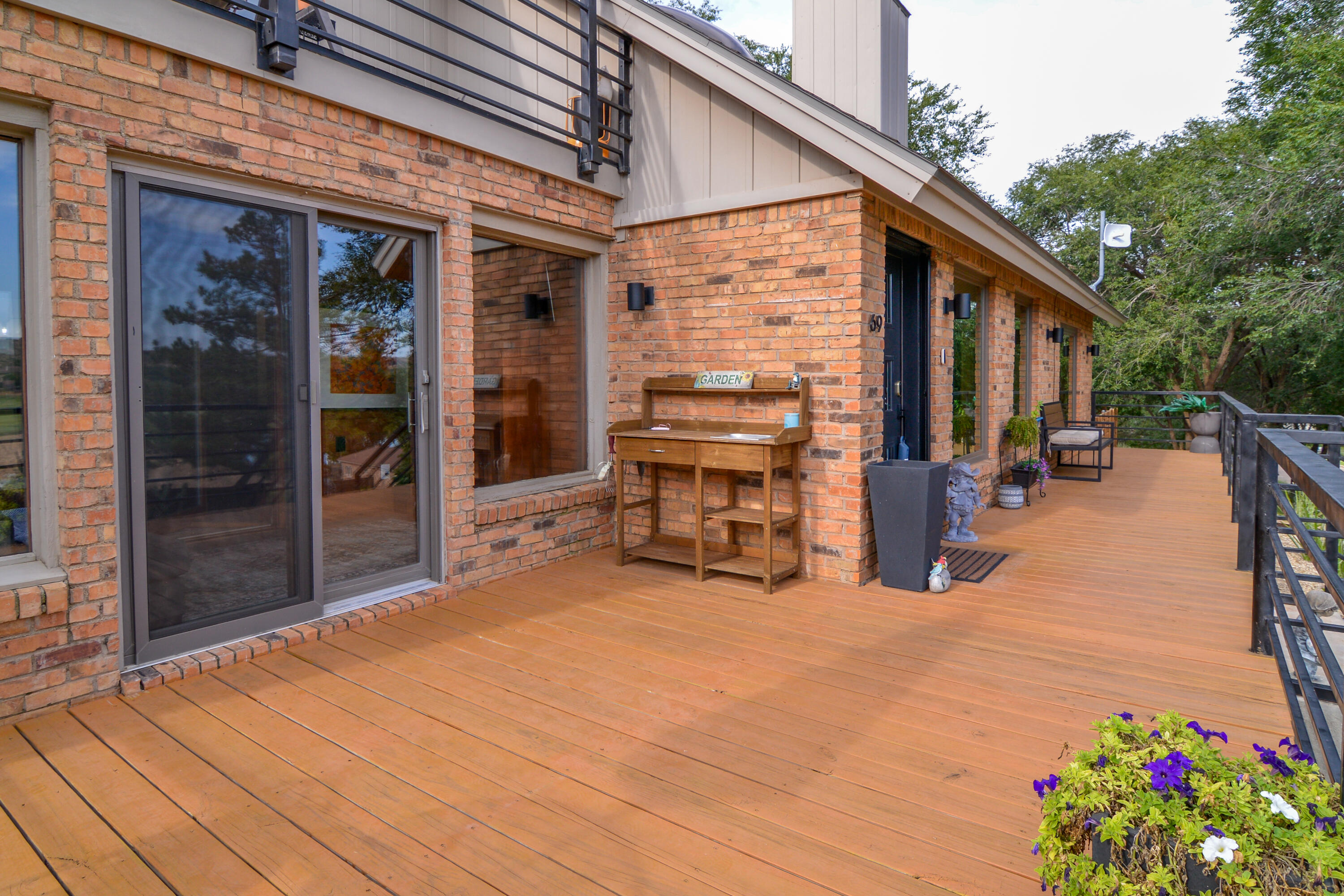 69 South Lake Shore Drive Ransom Canyon, TX 79366 - Photo 5 of 49 a view of a patio with table and chairs potted plants with wooden fence