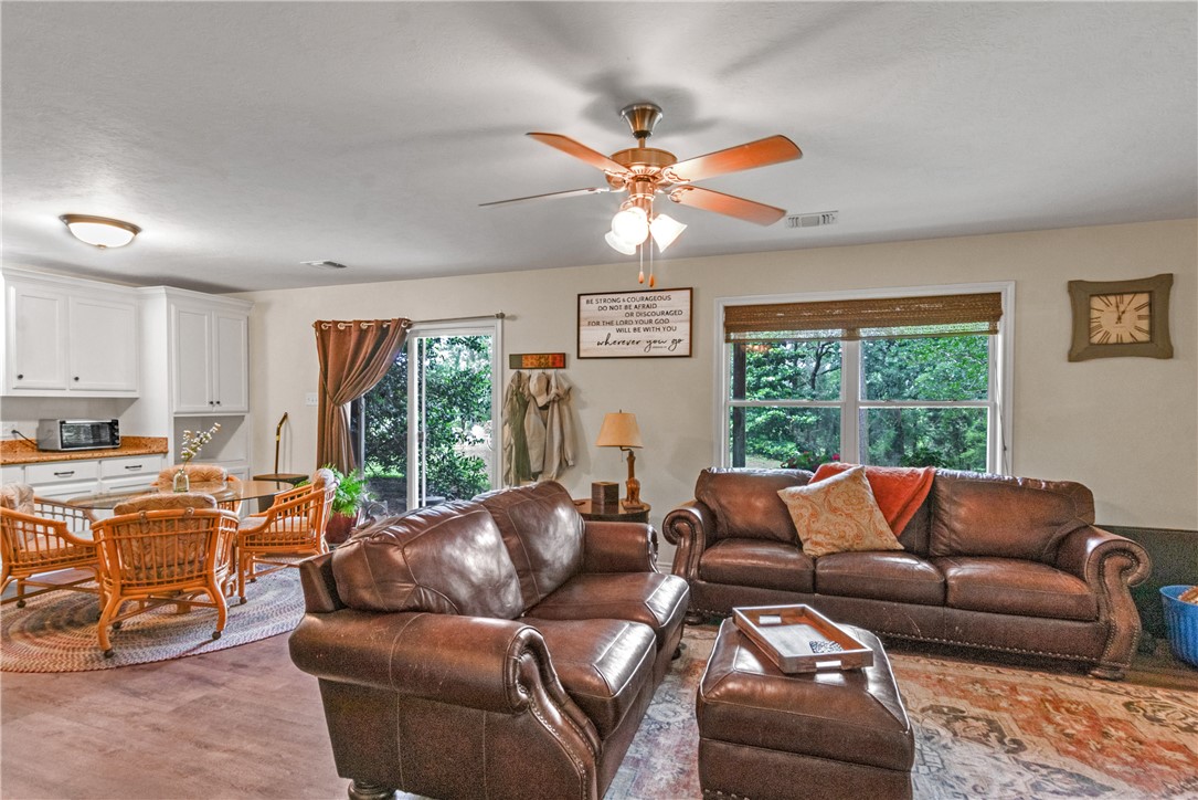 9997 Calhoun Road Bryan, TX 77808 - Photo 46 of 50 a living room with furniture a ceiling fan and a window
