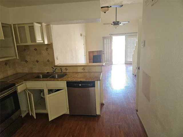 a bathroom with a granite countertop toilet sink and mirror