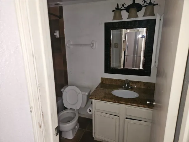 a bathroom with a toilet and shower