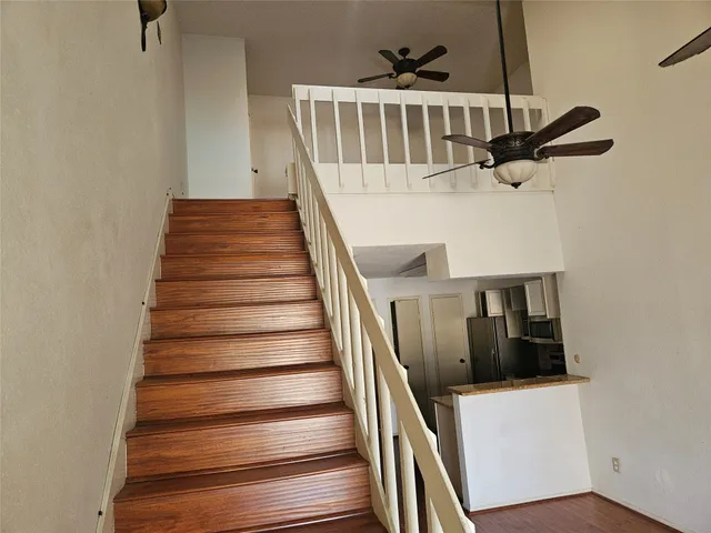 a view of empty room with wooden floor and fireplace