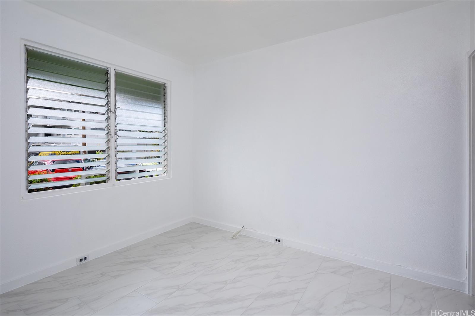 1115 Hassinger Street, Unit C Honolulu, HI 96822 - Photo 7 of 11 a view of an empty room and window