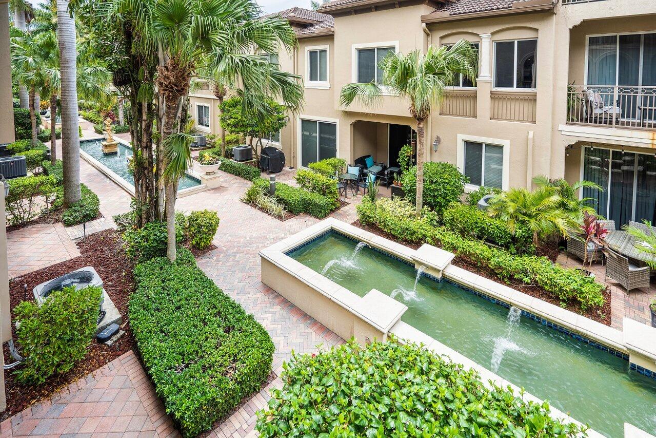 3025 Waterside Circle Boynton Beach, FL 33435 - Photo 29 of 36 front view of house with a yard and potted plants
