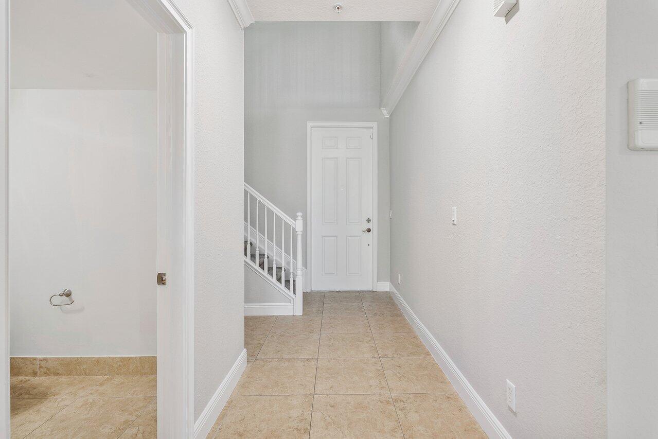 3025 Waterside Circle Boynton Beach, FL 33435 - Photo 4 of 36 a view of a hallway with white walls