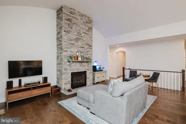 a kitchen with stainless steel appliances a refrigerator a stove a sink a dining table and chairs